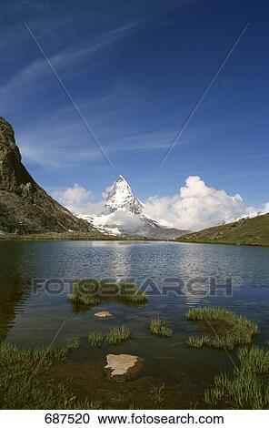 Lake with mountain in background, Matterhorn, Switzerland View Large Photo Image Stock Image - Lake with mountain in background, Matterhorn, Switzerland . Fotosearch