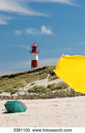 Lighthouse and parasols, Sylt, Schleswig-Holstein, Germany View Large Photo Image Stock Photography - Lighthouse and parasols, Sylt, Schleswig-Holstein, Germany . Fotosearch