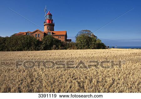 Stock Photo - Lighthouse and stubble field, Bastorf, Mecklenburg-Western Pomerania, Germany . Fotosearch