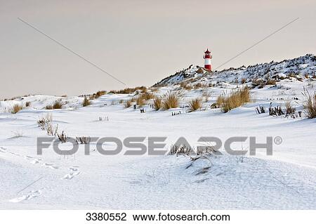 Stock Image - Lighthouse and winter landscape, List, Sylt, Schleswig-Holstein, Germany . Fotosearch