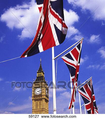 Stock Photo - Low angle view of clock tower and flags of France, London, France, Europe . Fotosearch