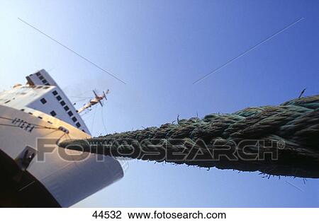 Stock Image - Low angle view of rope and ship . Fotosearch