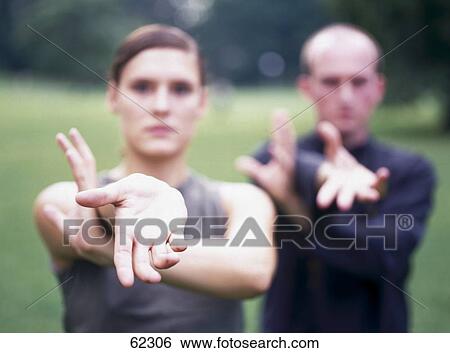 Man and woman doing Tai Chi outside View Large Photo Image Stock Photograph - Man and woman doing Tai Chi outside . Fotosearch