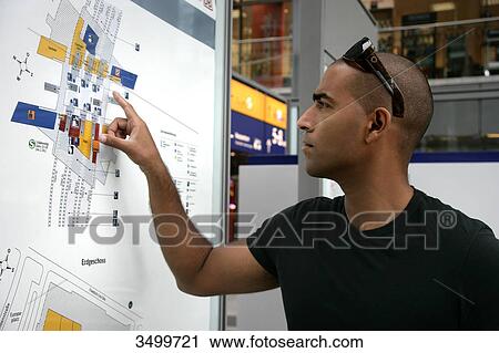 Man looking at information board, low angle view View Large Photo Image Stock Image - Man looking at information board, low angle view . Fotosearch