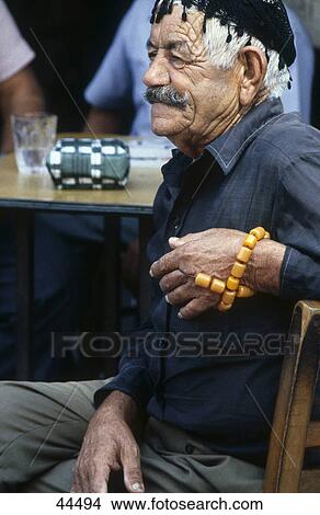 Picture - Man sitting at outdoor cafe, Crete Island, Greece . Fotosearch