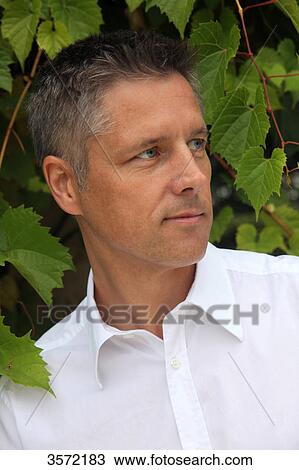 Man wearing white shirt outdoors View Large Photo Image Stock Image - Man wearing white shirt outdoors . Fotosearch