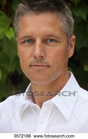 Man wearing white shirt outdoors, portrait View Large Photo Image Stock Photograph - Man wearing white shirt outdoors, portrait . Fotosearch
