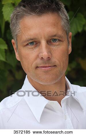 Man wearing white shirt outdoors, portrait View Large Photo Image Stock Photography - Man wearing white shirt outdoors, portrait . Fotosearch