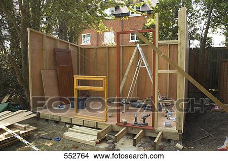 Partly constructed log cabin in front of building View Large Photo Image Picture - Partly constructed log cabin in front of building . Fotosearch