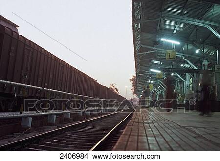 People waiting at railway platform, Hospet, Karnataka, India View Large Photo Image Picture - People waiting at railway platform, Hospet, Karnataka, India . Fotosearch