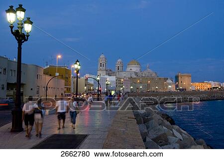 People walking on pavement near coast, Costa de la Luz, Cadiz, Andalusia, Spain View Large Photo Image Stock Image - People walking on pavement near coast, Costa de la Luz, Cadiz, Andalusia, Spain . Fotosearch