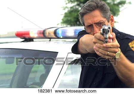 Policeman holding gun View Large Photo Image Stock Image - Policeman holding gun . Fotosearch