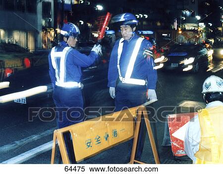 Stock Photography - Policemen at construction site on road, Shinjuku, Tokyo, Japan . Fotosearch