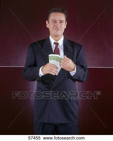 Portrait of businessman holding banknotes View Large Photo Image Stock Photography - Portrait of businessman holding banknotes . Fotosearch