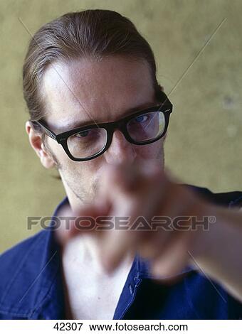 Portrait of young man pointing towards camera View Large Photo Image Stock Photo - Portrait of young man pointing towards camera . Fotosearch
