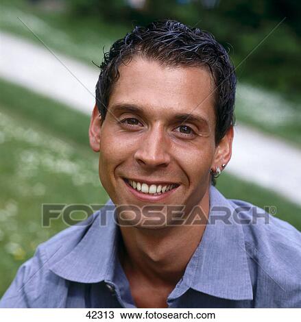 Stock Image - Portrait of young man smiling . Fotosearch
