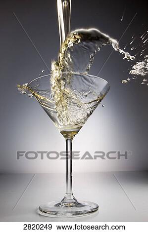 Stock Photo - pouring champagne into a glass, close-up . Fotosearch