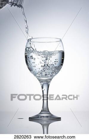pouring in of water into a glass, close-up View Large Photo Image Stock Image - pouring in of water into a glass, close-up . Fotosearch