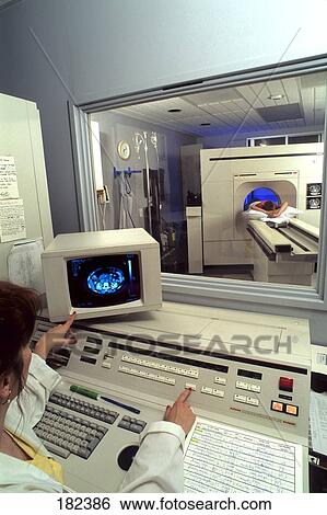 Radiologist working with CAT scans on computer View Large Photo Image Stock Photograph - Radiologist working with CAT scans on computer . Fotosearch