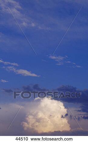 Stock Image - Raincloud in evening light . Fotosearch