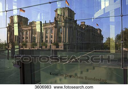 Stock Image - Reichstag reflecting in glass front of Marie-Elisabeth-Lueders-Haus, Berlin, Germany . Fotosearch