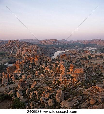 Stock Image - River flowing through rocky landscape, Tungabhadra River, Karnataka, India . Fotosearch
