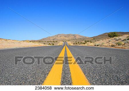 Stock Photo - Road running through landscape, Nevada, USA . Fotosearch