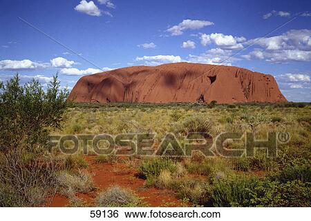 Stock Photograph - Rock formations on a landscape, Ayers skirt, Uluru National Park, Northern Territories, Australia . Fotosearch