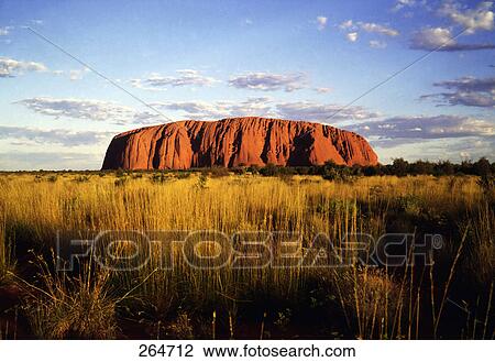 Stock Image - Rock formations on landscape, Uluru, Uluru-Kata Tjuta National Park, Northern Territory, Australia . Fotosearch
