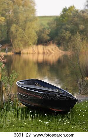 Rowing boat at lakeside, Finkenwerder, Hamburg, Germany View Large Photo Image Stock Photo - Rowing boat at lakeside, Finkenwerder, Hamburg, Germany . Fotosearch