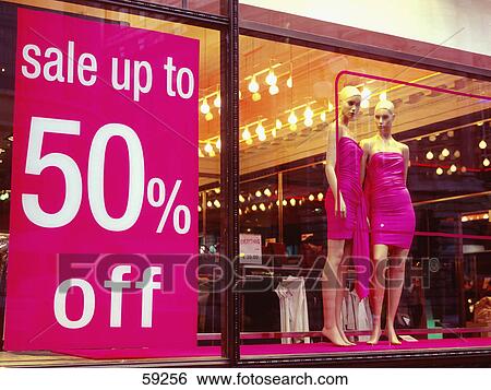 Stock Photograph - Sale poster pasted on shop window . Fotosearch