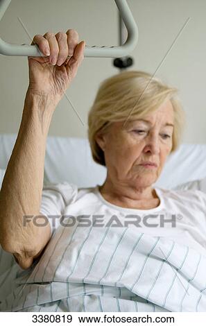 Stock Photo - Senior woman in hospital bed . Fotosearch