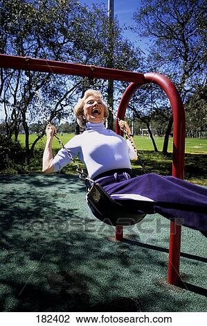 Senior woman sitting on swing View Large Photo Image Stock Image - Senior woman sitting on swing . Fotosearch