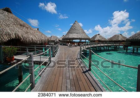 Stock Image - Shacks in shallow water, Tuamotu Archipelago, French Polynesia, Polynesia, Pacific Island . Fotosearch