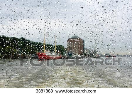 Stock Photo - Ship on the Elbe seen through window pane covered with raindrops, Hamburg, Germany . Fotosearch