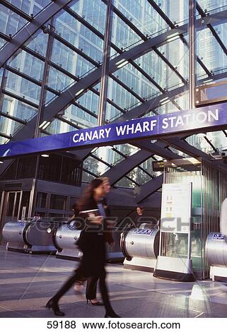 Side profile of woman entering escalator, Canary Wharf, London, France, Europe View Large Photo Image Stock Photo - Side profile of woman entering escalator, Canary Wharf, London, France, Europe . Fotosearch