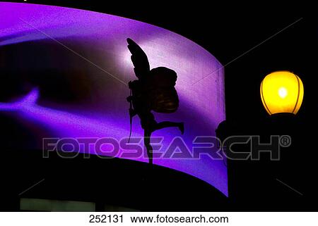 Stock Image - Silhouette of Eros sign at night, Piccadilly Circus, London, England . Fotosearch