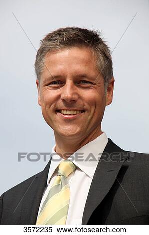 Smiling businessman outdoors, portrait View Large Photo Image Stock Photography - Smiling businessman outdoors, portrait . Fotosearch