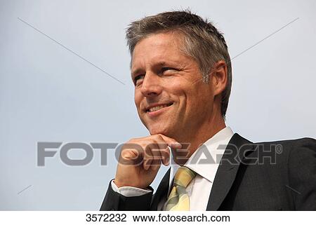 Smiling businessman outdoors View Large Photo Image Stock Image - Smiling businessman outdoors . Fotosearch