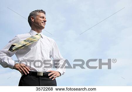 Smiling businessman outdoors View Large Photo Image Stock Photo - Smiling businessman outdoors . Fotosearch
