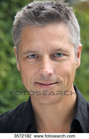 Stock Image - Smiling man outdoors, portrait . Fotosearch