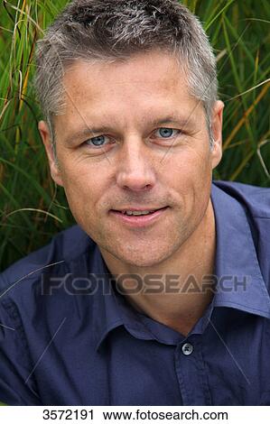 Stock Image - Smiling man outdoors, portrait . Fotosearch