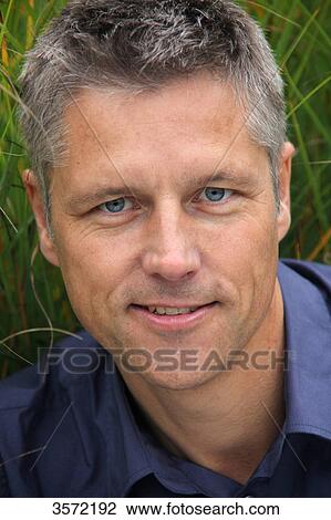 Smiling man outdoors, portrait View Large Photo Image Stock Image - Smiling man outdoors, portrait . Fotosearch