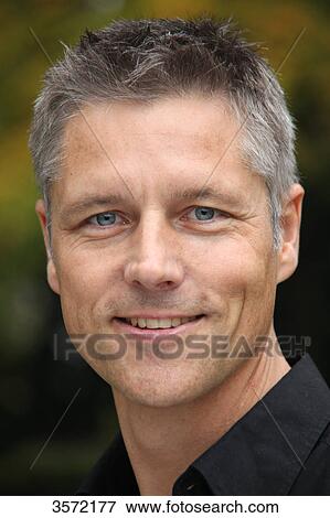 Stock Photo - Smiling man outdoors, portrait . Fotosearch