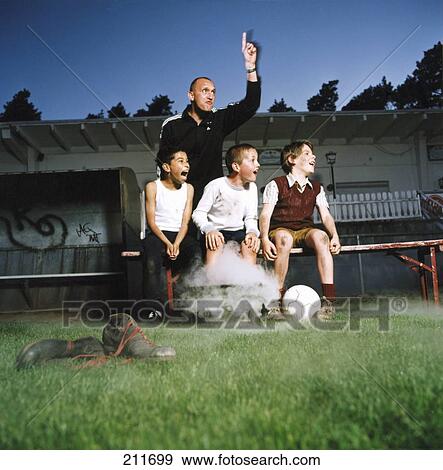 Soccer trainer and three boys shouting in stadium View Large Photo Image Stock Photo - Soccer trainer and three boys shouting in stadium . Fotosearch