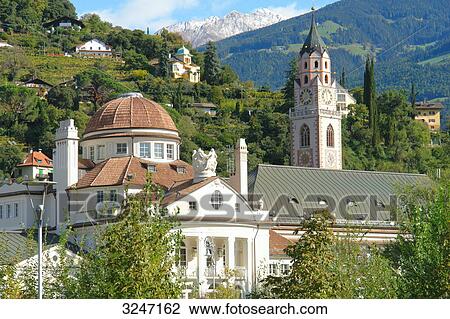 Stock Image - Stadtkirche St, Nikolaus and spa hotel, Meran, south Tyrol, Italy . Fotosearch