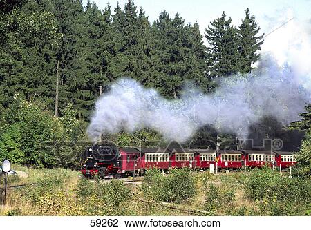 Stock Image - Steam train on landscape, Saxony Anhalt, Germany . Fotosearch