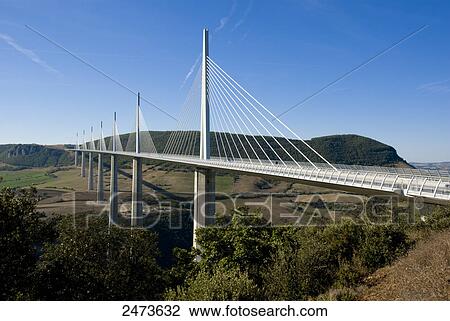 Stock Image - Suspension bridge with mountains in background, Millau, Aveyron, Midi-Pyrenees, France . Fotosearch