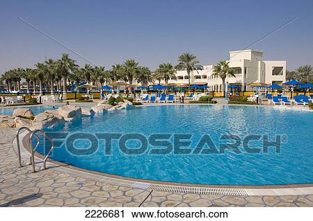 Stock Image - Swimming pool in tourist resort, Sealine Beach Resort, Mesaieed, Qatar . Fotosearch