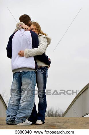 Stock Image - Teenage couple embracing . Fotosearch
